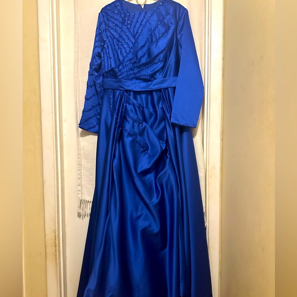 Beautiful satin blue dress with sequins details in bodice and sleeve.